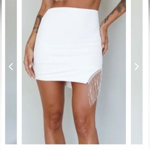 White skirt with rhinestone slit.